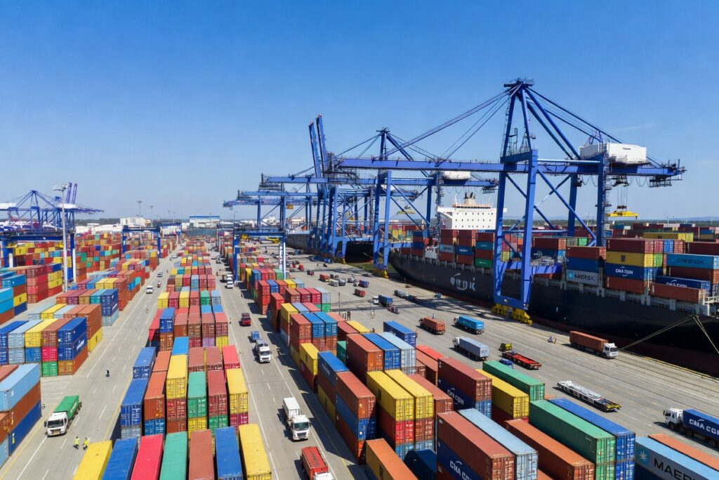 Aerial view of a Chinese container port terminal with gantry cranes loading a container ship